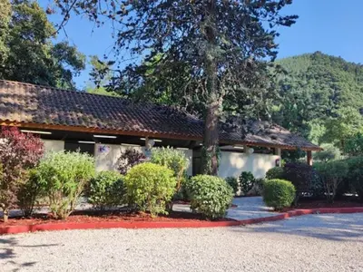 a building with a bunch of bushes in front of it at Mobil home 21m² avec terrasse à Axat - API-1-52-1082 in Axat