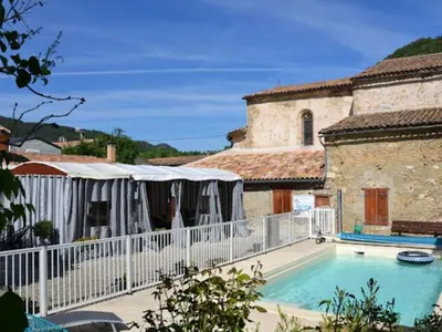 a house with a swimming pool next to a building at Chalet 4 pers avec terrasse à Roquefeuil - API-1-52-236 in Roquefeuil