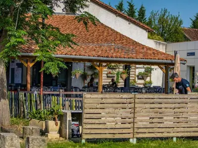 a man standing in front of a house at Mobil-Home 2 Chambres avec Terrasse - API-1-52-1325 in Vielmur-sur-Agout