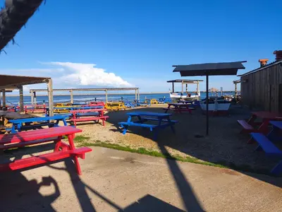 a group of picnic tables in front of the ocean at Appartement T2 à Gruissan - Piscine & Parking, 2/3 Pers. - FR-1-796-107 in Gruissan