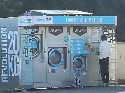 a woman standing in front of a laundry machine at Chalet 6 pers avec Terrasse & Jardin - API-1-52-1952 in Pamiers