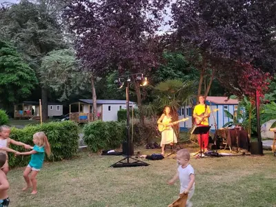 a group of children playing in a yard with a band at Chalet Confortable avec Terrasse - 5 pers - API-1-52-1957 in Pamiers