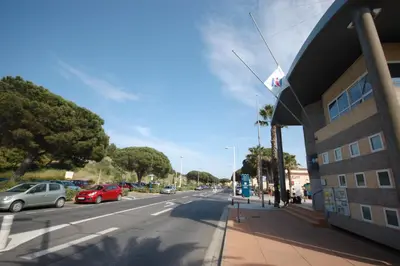 a city street with cars parked on the side of a building at Studio Moderne - Plage du Grazel in Gruissan