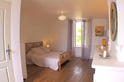 a bedroom with a bed and a window at Chambres d'hôtes La Luciole in Tourtrol