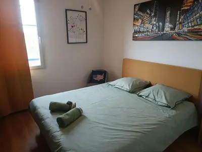 a bed with two pillows on it in a bedroom at Chambre avec petit déjeuner in Carcassonne