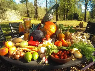 a table with a bunch of vegetables on it at La Bouriotte, chambre d'hôtes Sycomore, in Labastide-Rouairoux