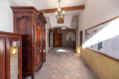 a hallway with a large wooden cabinet in a building at Studio du couvent in Narbonne