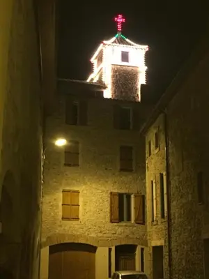 a building with a red cross on top of it at night at Chambre du couvent in Narbonne