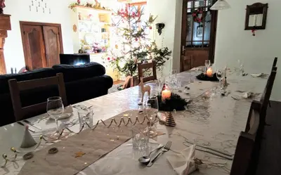 a table with a christmas tree in a living room at Chez Providence Chambres et Table d'Hôtes in Cuxac-Cabardès
