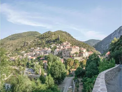 a small town on a mountain with a road at Roquebrun Villa with Pool in Roquebrun