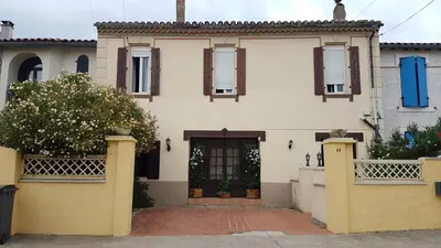 a house with a gate and a door at Hibiscus House in Carcassonne