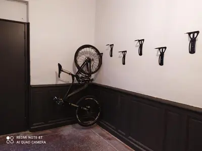 a bicycle is hanging on a wall with numbers on it at Le Selamat, Logis XXL au calme avec Terrasse in Carcassonne