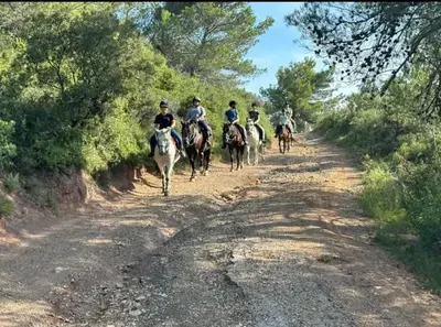 a group of people riding horses down a dirt road at La Villa Du Menhir Chambre d'hôtes in Bize-Minervois