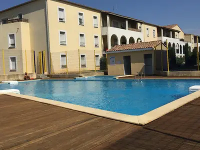 a large swimming pool in front of a building at Les Capucins in Carcassonne