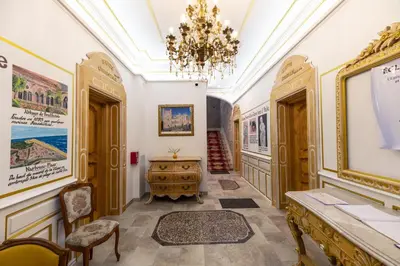 a hallway with a chandelier and a table and chairs at Studio Romantique Maison de L'église du Couvent in Narbonne