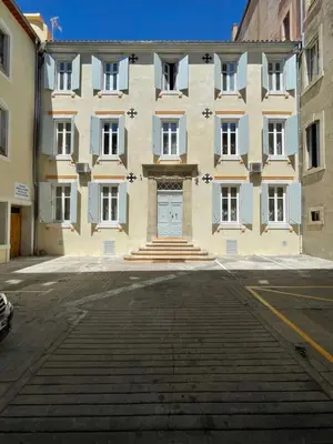 a large building with a door in a street at Suite Orientale Maison de L'église du Couvent in Narbonne