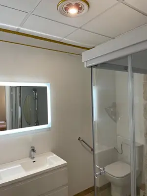 a bathroom with a toilet and a sink and a mirror at Studio familial Maison de L'église du Couvent in Narbonne