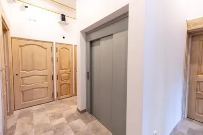 a sliding door in a hallway with wooden doors at Appartement Maison de L'Église du Couvent in Narbonne