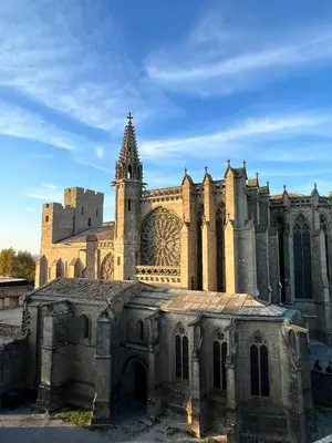 an old church with a tower in front of it at Le Rêve Bleu Appartement Hyper-centre in Carcassonne