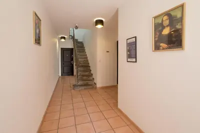 a hallway with a staircase in a house at Baignoire Cosy Centre Narbonne in Narbonne