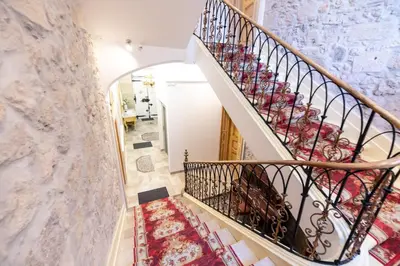 a staircase in a home with a marble wall at Chambre Familiale Maison de L'Église du Couvent in Narbonne