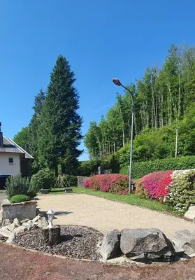a park with flowers and a light pole at L'ECRIN DU LAC - L'Ortencia in Mazamet