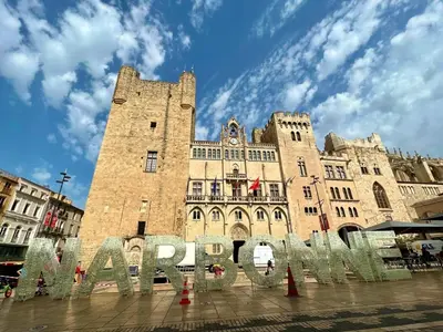 a large building with a sign in front of it at Coural' Chic in Narbonne