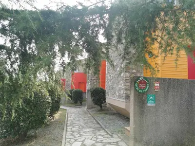 a walkway in front of a building with trees at Rouvenac in Trilla