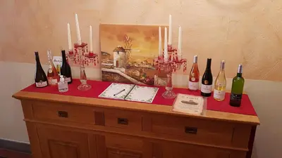 a table with a bunch of bottles of wine on it at Hong Kong Guest room in the heart of the vineyard no69 in Badens