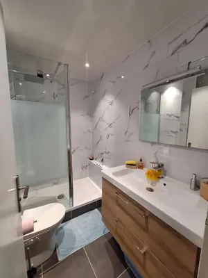 a bathroom with a shower and a sink and a tub at Agréable Studio en bord de mer in Port-la-Nouvelle