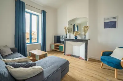 a living room with a couch and a fireplace at L'Apothicaire Proche des Halles in Narbonne