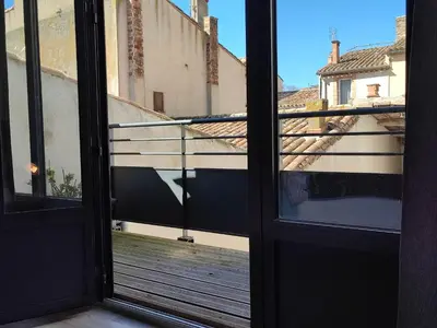a view of a balcony from an open door at Le Gabin Moderne Loft in Carcassonne