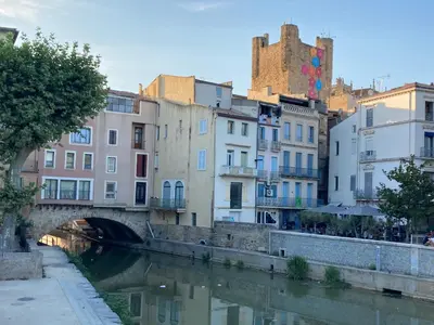 a bridge over a river in a city with buildings at NATURE by Reine du Sud, proche des Grands Buffets in Narbonne