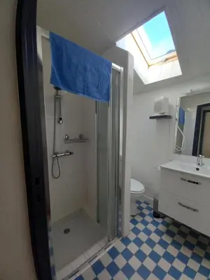 a bathroom with a shower with a shower curtain at Charmant T2 indépendant in Belcaire